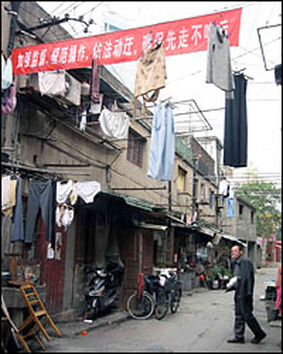 Red banners, encouraging residents to move out as soon as possible, festoon the neighborhood.