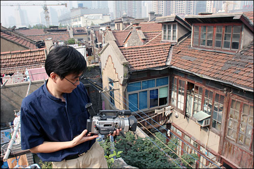 photo by Lu Jie, Haolun Shu films his old neighborhood from a rooftop. 