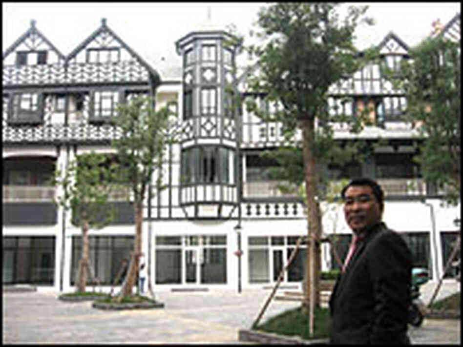 Thames Town developer James Ho stands in front of a facsimile of a half-timbered Tudor house.