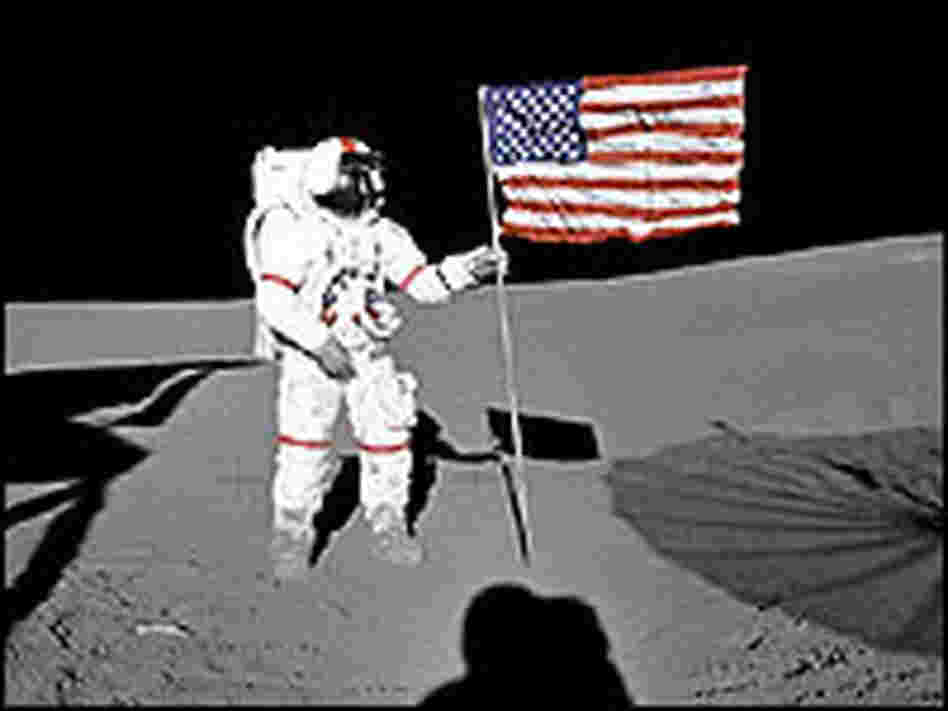 Astronaut Alan Shepard Jr., Apollo 14 commander, plants the U.S. flag on the moon.