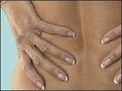 A woman holding her lower back.
