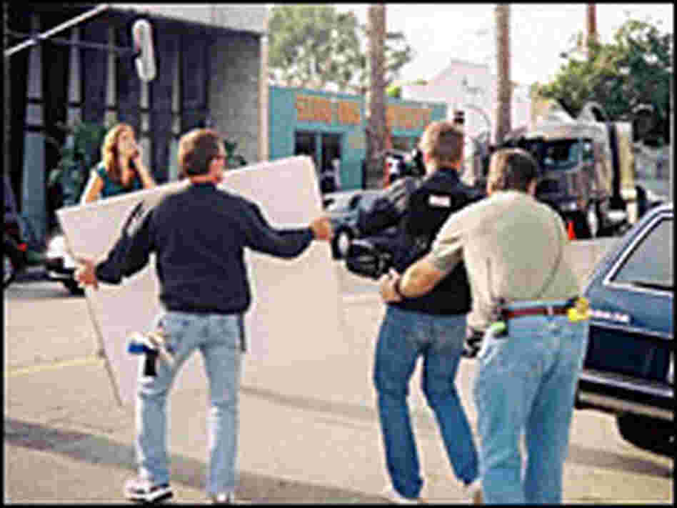 Dagg (from the back) guides the camera operator backwards 