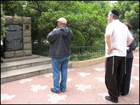 Tourists visit a memorial stone dedicated to the Jews who fled the Nazis to Shanghai.