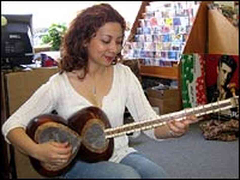 Sahba Motallebi plays a traditional stringed instrument called a tar at the Ketab Bookshop.
