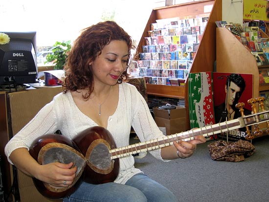 Sahba Motallebi plays a traditional stringed instrument called a tar at the Ketab Bookshop.