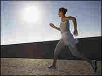 A woman jogging in the sun. A woman jogging in the sun.