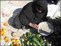 An Iraqi woman lays rotten fruits and vegetables at the side of a busy road in Basra. An Iraqi woman lays rotten fruits and vegetables at the side of a busy road in Basra.