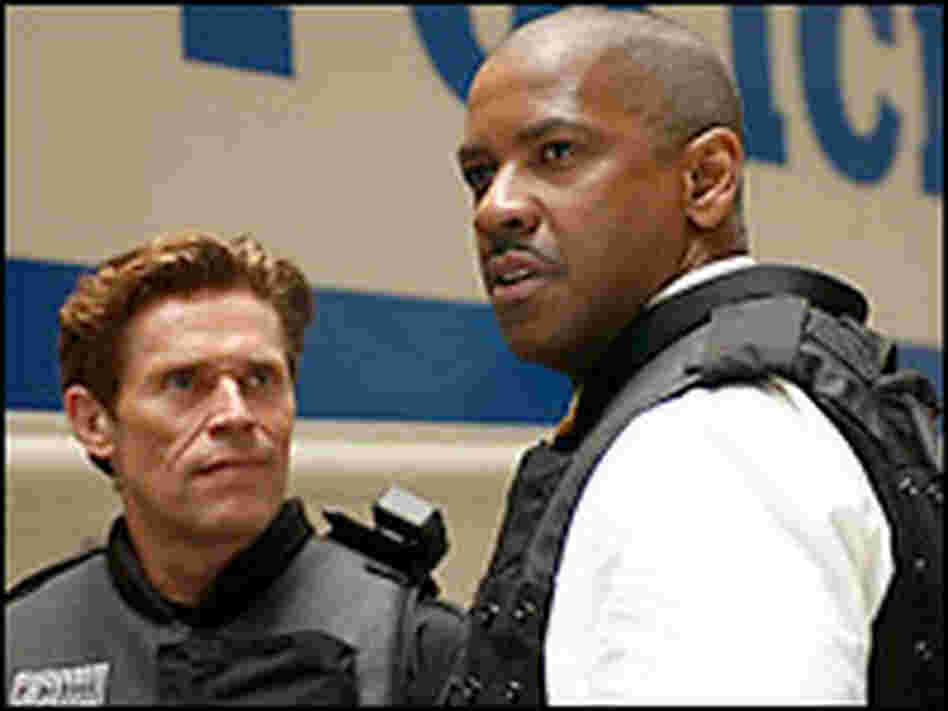 Denzel Washington (right) and Willem Dafoe. Credit: Universal Pictures. Denzel Washington (right) and Willem Dafoe. Credit: Universal Pictures.