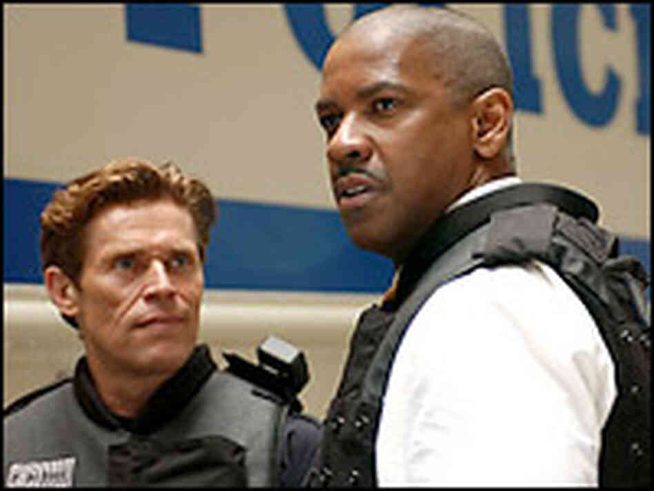 Denzel Washington (right) and Willem Dafoe. Credit: Universal Pictures. Denzel Washington (right) and Willem Dafoe. Credit: Universal Pictures.