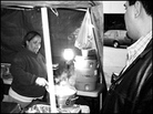 Janete serves up a plate for a late-night customer. Janete serves up a plate for a late-night customer.
