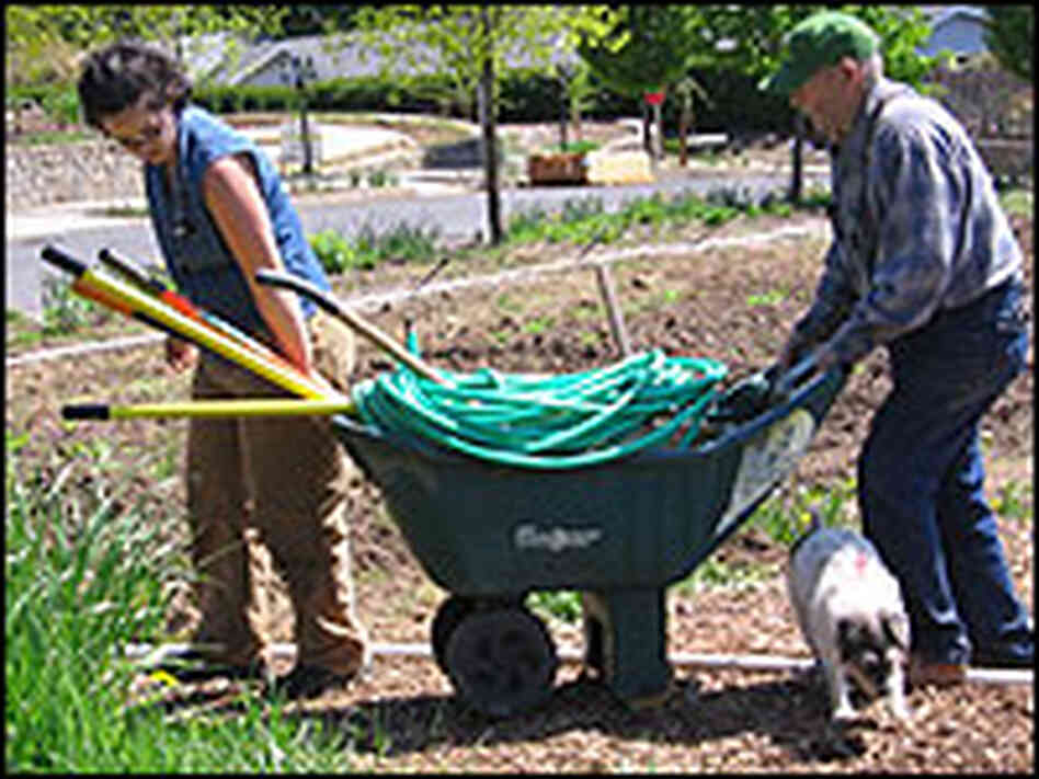 Landscaper Melissa Richmond, left, gets some help from resident Francis Zetterberg Landscaper Melissa Richmond, left, gets some help from resident Francis Zetterberg