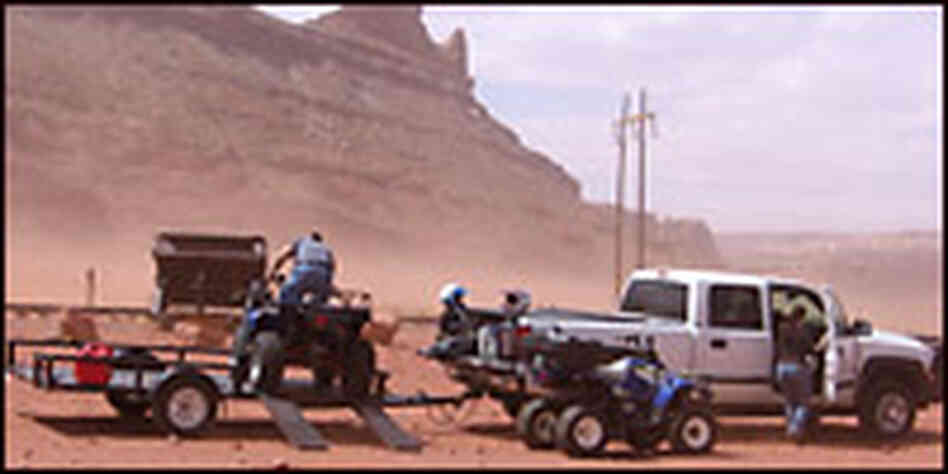 People preparing to ride an ATV in the desert. Credit: Richard Harris, NPR.