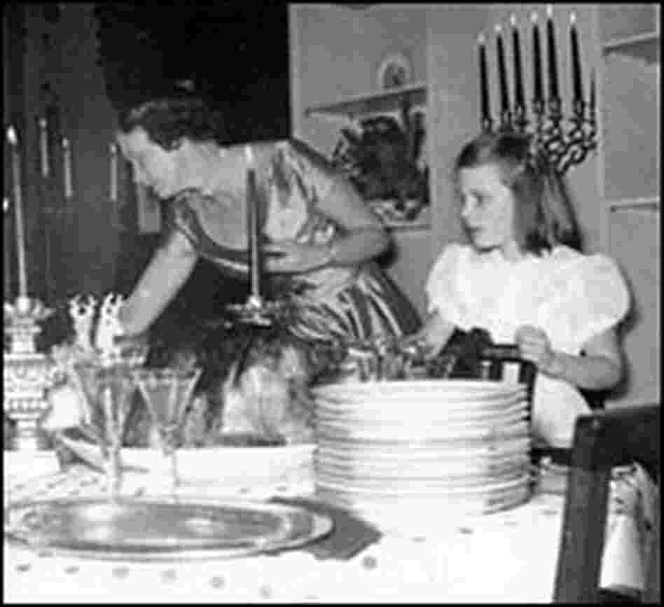 Peggy Knickerbocker helps her mother set the table. Peggy Knickerbocker helps her mother set the table.