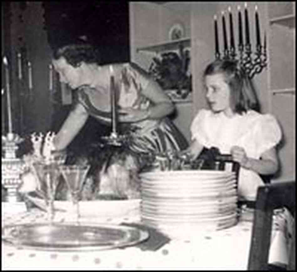 Peggy Knickerbocker helps her mother set the table. Peggy Knickerbocker helps her mother set the table.