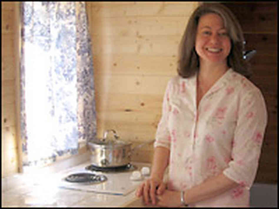 Julie Martin with her tiny home in Mississippi. Cheryl Corley, NPR. Julie Martin with her tiny home in Mississippi. Cheryl Corley, NPR.