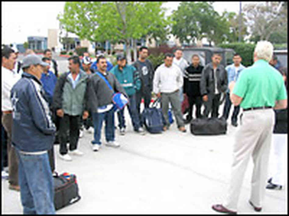 Controller John Demoss welcomes guest workers to Benchmark in San Diego. Credit: Scott Horsley, NPR.