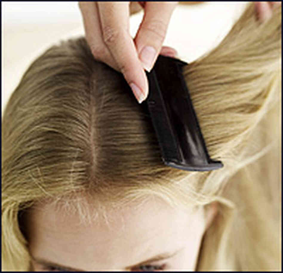 A woman combs a girl's hair. A woman combs a girl's hair.