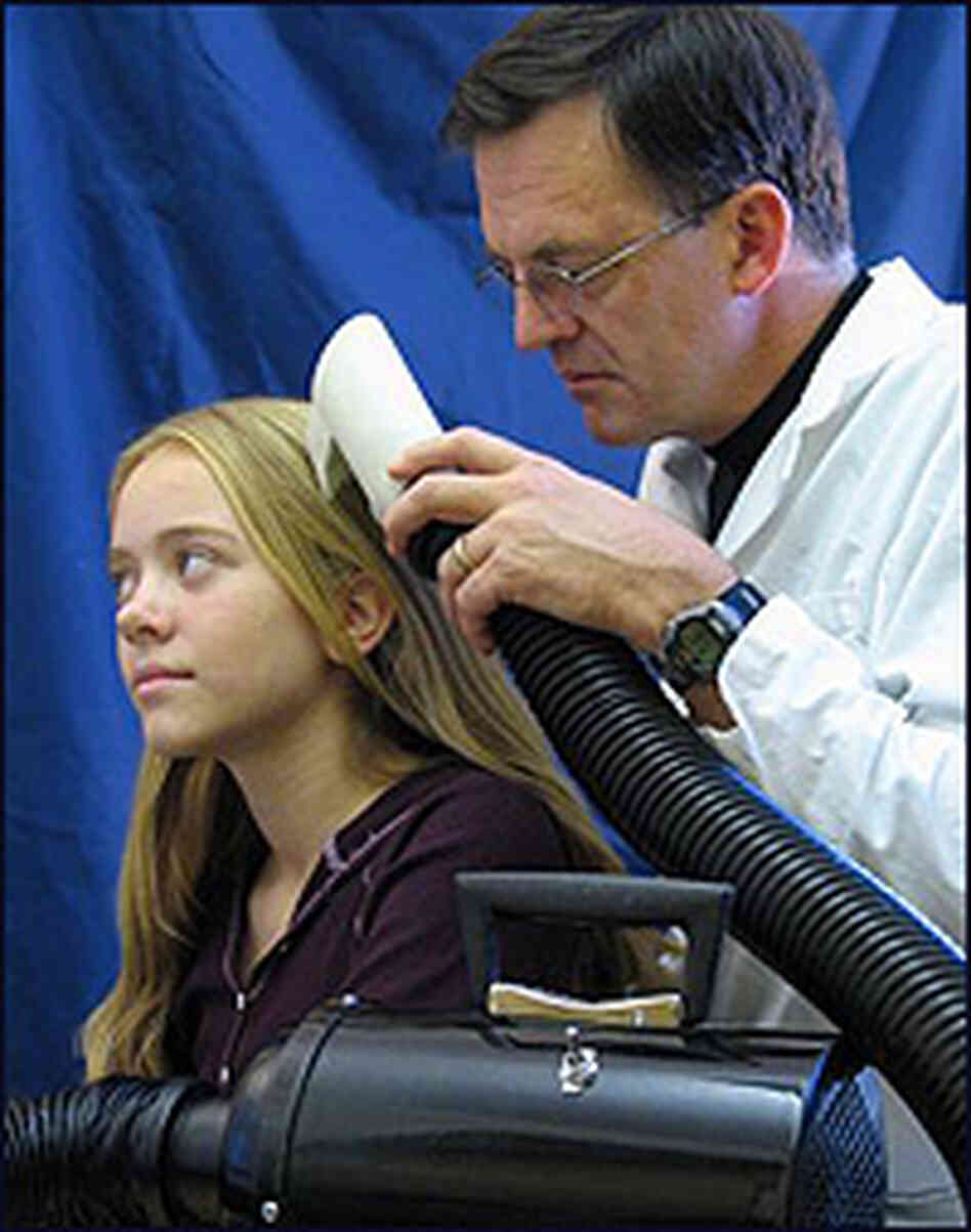University of Utah biologist Dale Clayton demonstrates the LouseBuster on his daughter. University of Utah biologist Dale Clayton demonstrates the LouseBuster on his daughter.