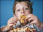 A boy eating French fries. A boy eating French fries.