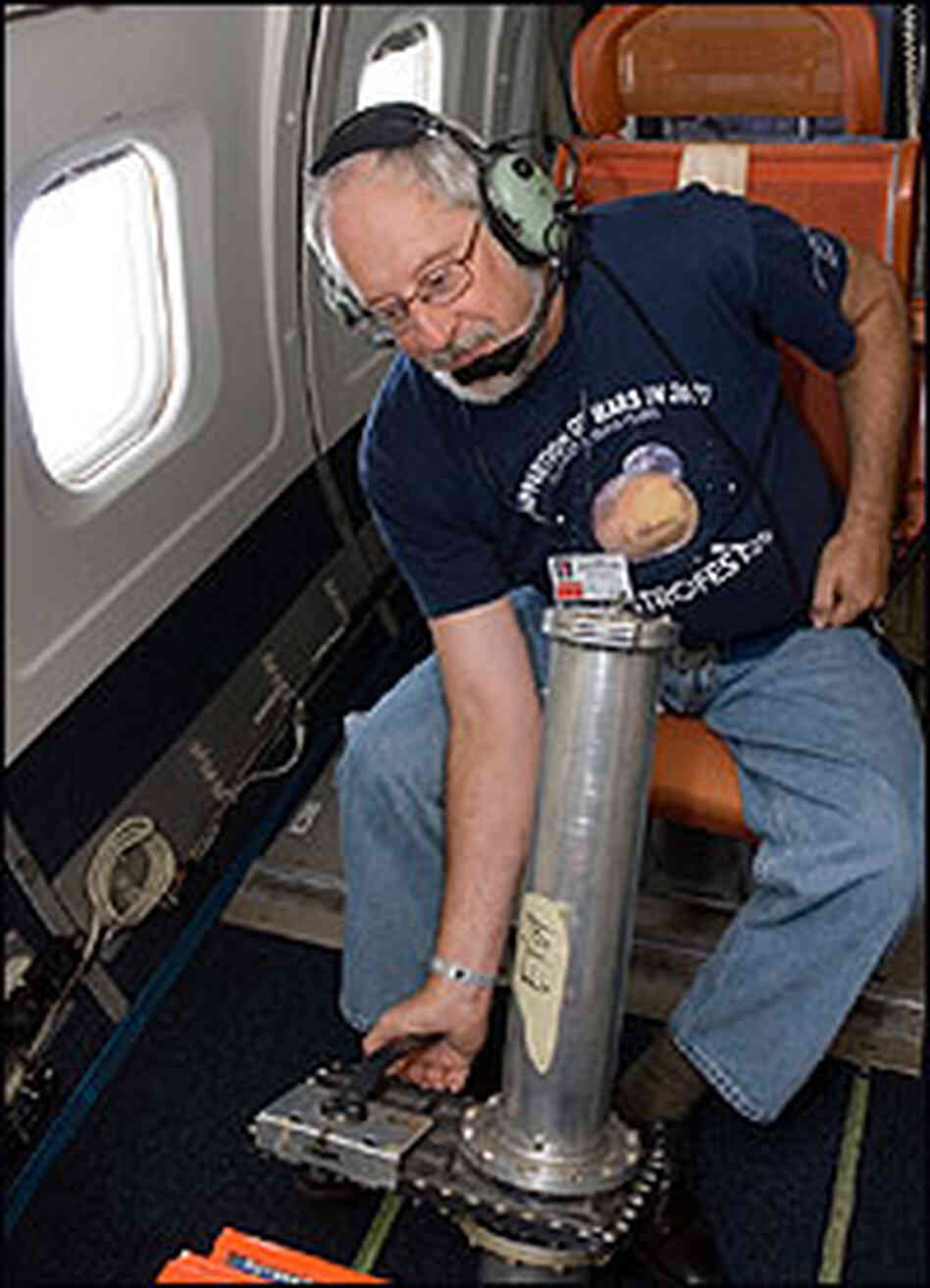 Bob Pasken, of St. Louis University, launches a dropsonde from the DC-8 plane. Bob Pasken, of St. Louis University, launches a dropsonde from the DC-8 plane.