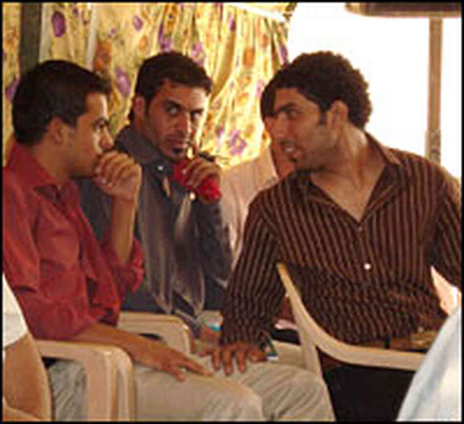 Sadiq Hattab talks with other poets from Sadr City. Sadiq Hattab talks with other poets from Sadr City.