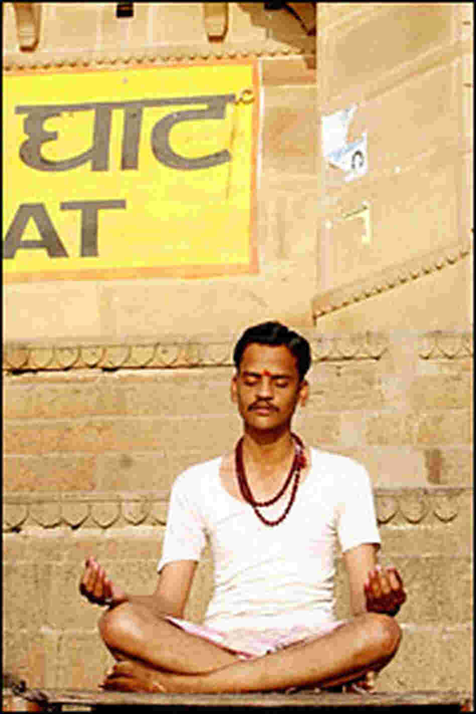 In Varanasi, one of Hinduism's holiest cities, a man meditates in the early morning