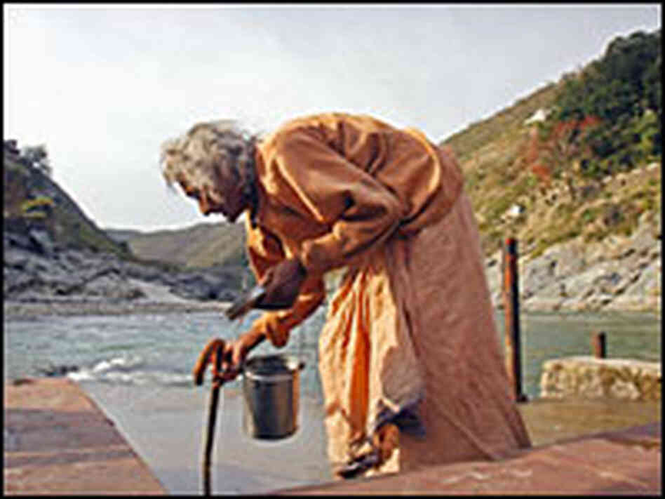 A woman collects water at one of the ghats, or steps, down to the shore of the Ganges.