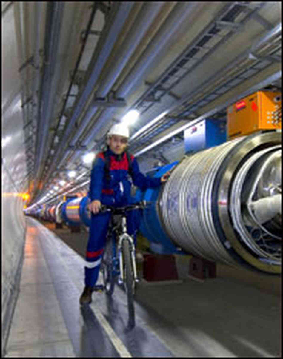A CERN staffer sits atop a bike in the accelerator's 16-mile  tunnel.