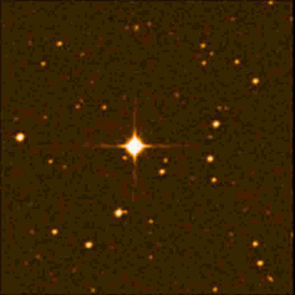 A photo of the red dwarf star, Gliese 581, surrounded by many other stars.