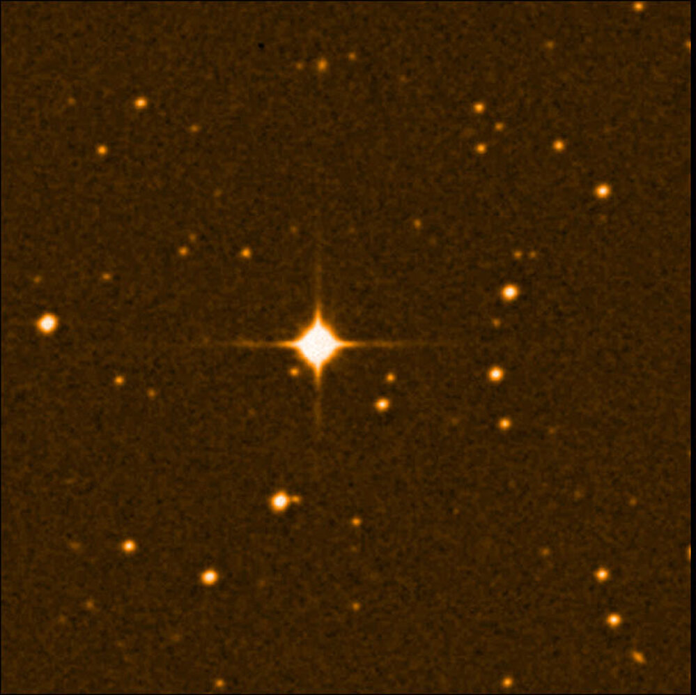 A photo of the red dwarf star, Gliese 581, surrounded by many other stars.