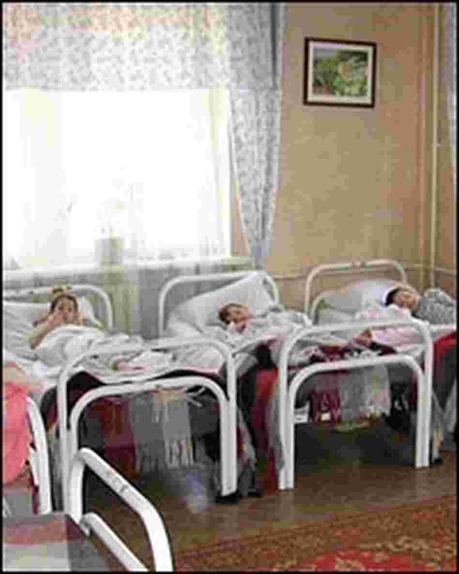 Children lie in beds at the Internat No. 8 boarding school.