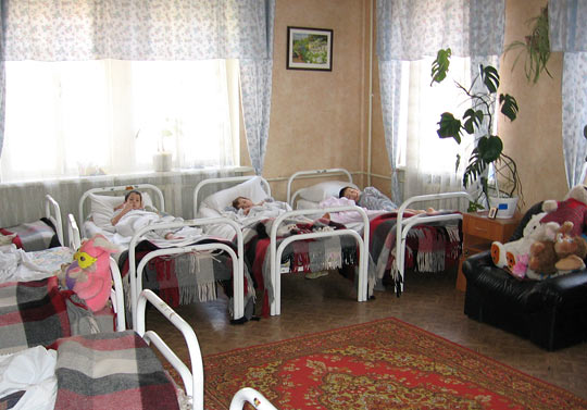 Children lie in beds at the Internat No. 8 boarding school.