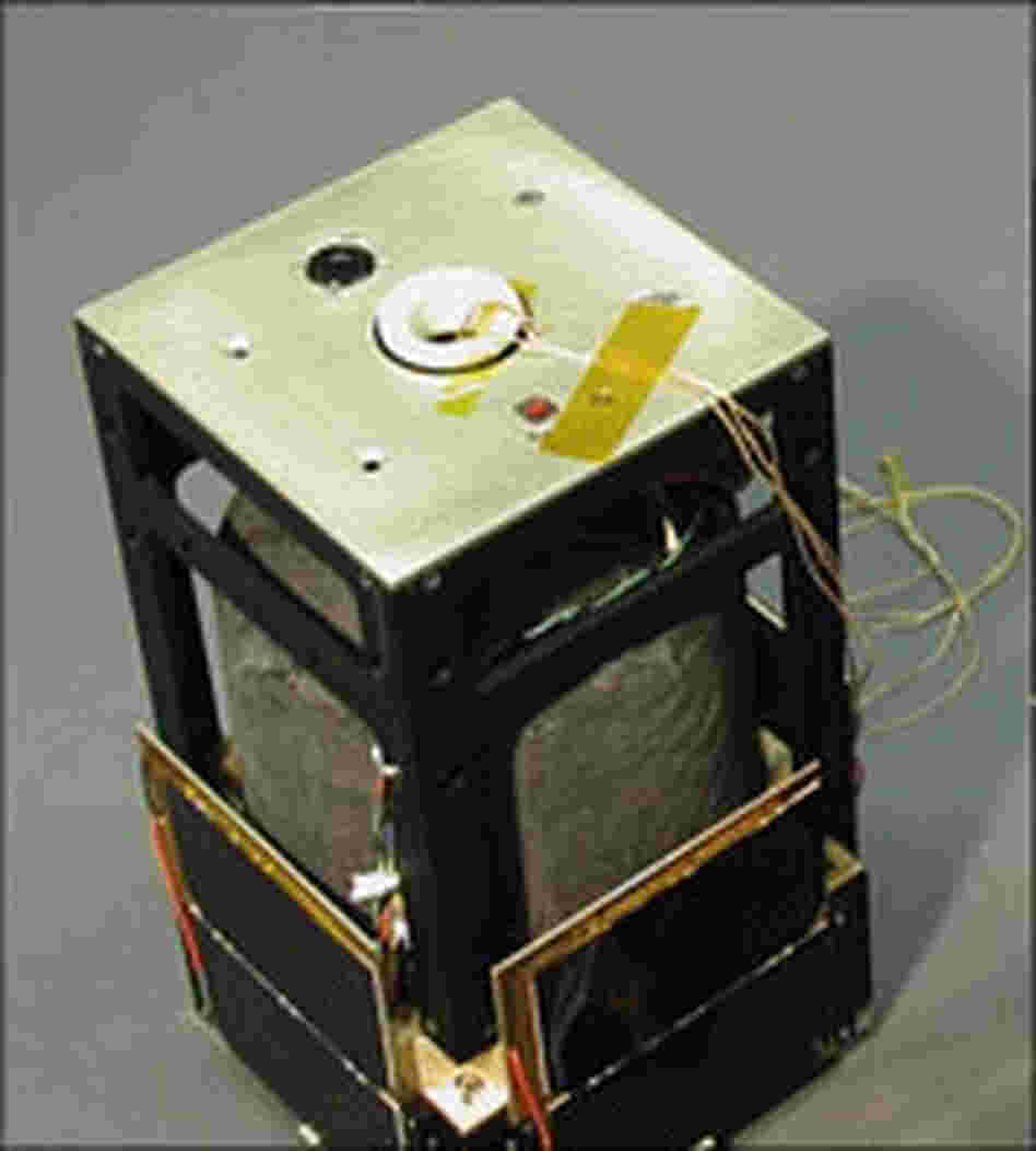 The tether, a thin yellow woven string, comes out of one end of a satellite.