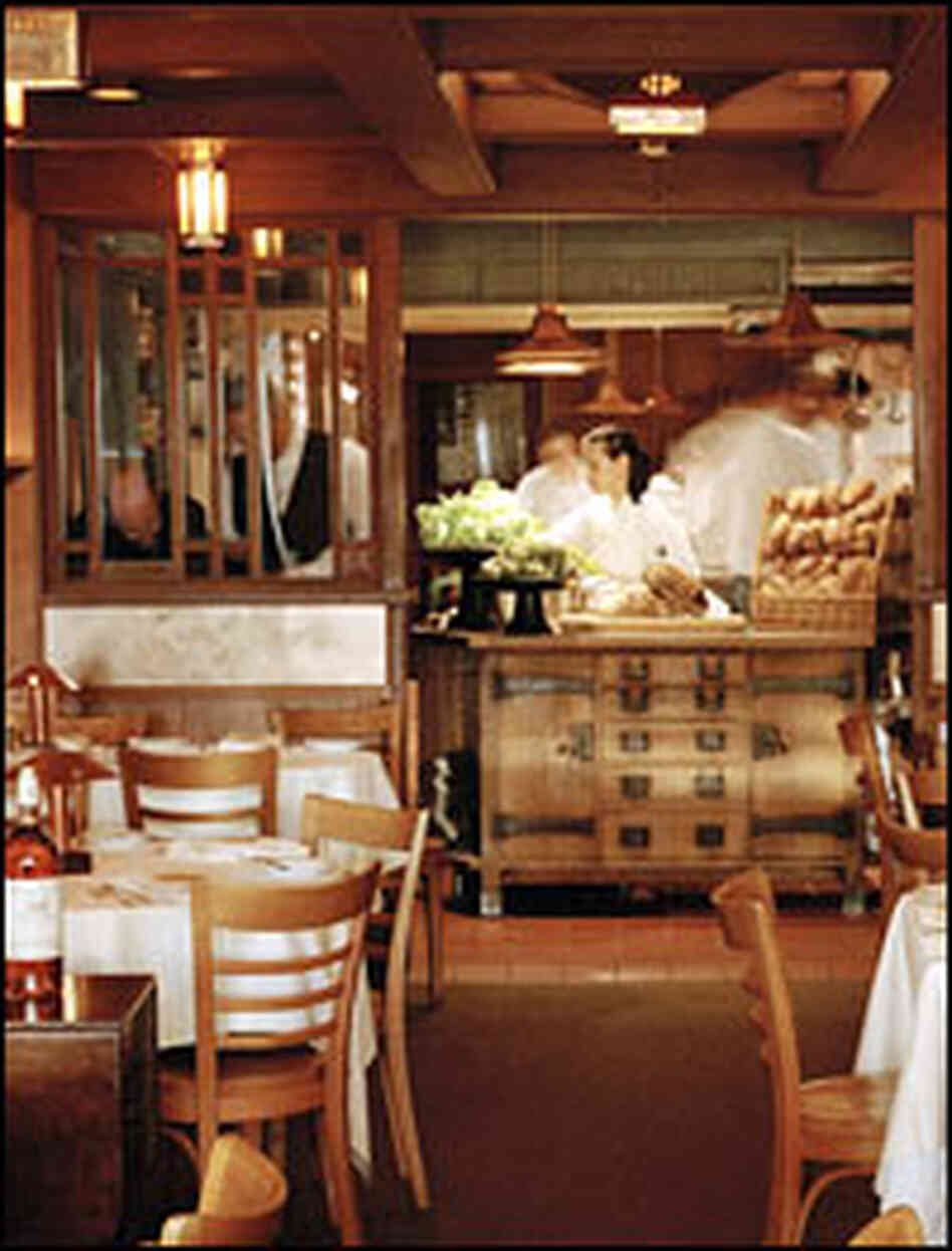 The dining room at Chez Panisse offers a view of the kitchen.