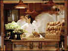 The dining room at Chez Panisse offers a view of the kitchen.