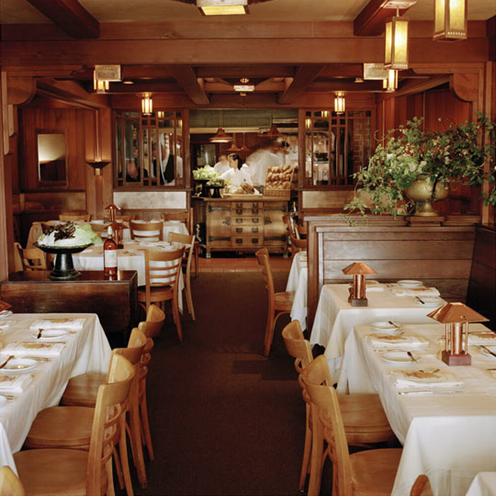 The dining room at Chez Panisse offers a view of the kitchen.