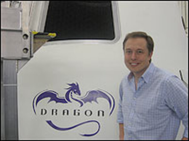 Musk stands by a "Dragon" capsule. He hopes to one day be able to carry seven people to orbit.