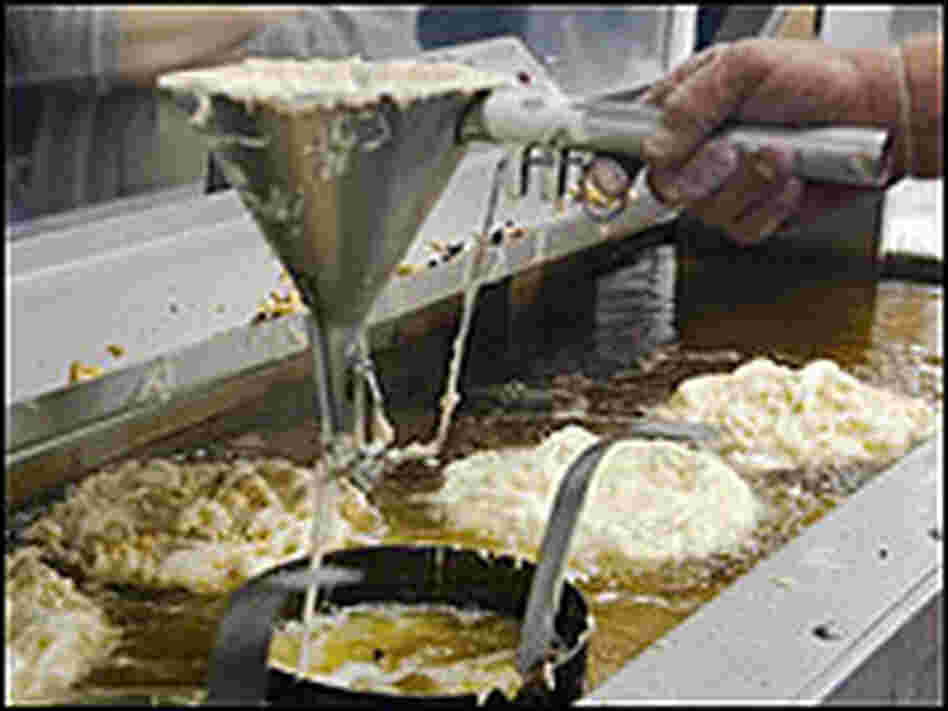 A man making funnel cakes at a fair.
