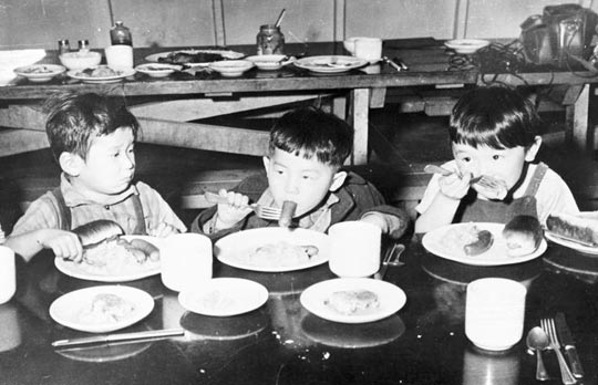 Children eat hot dogs at Idaho's Minidoka Internment Camp.