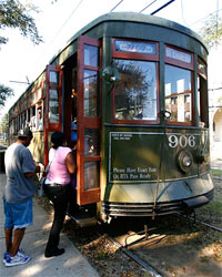 Passengers board the St. Charles Avenue streetcar. The line uses the same streetcars the city bought in 1923. Photo: Chris Graythen/Getty Images