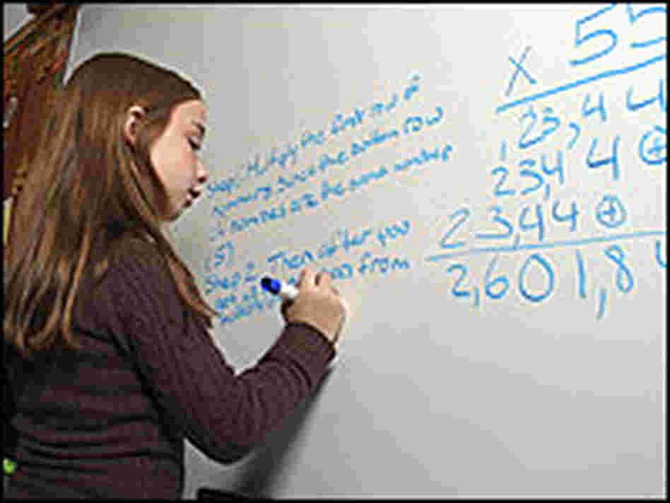 A girl works on a math problem. A girl works on a math problem.