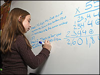 A girl works on a math problem.