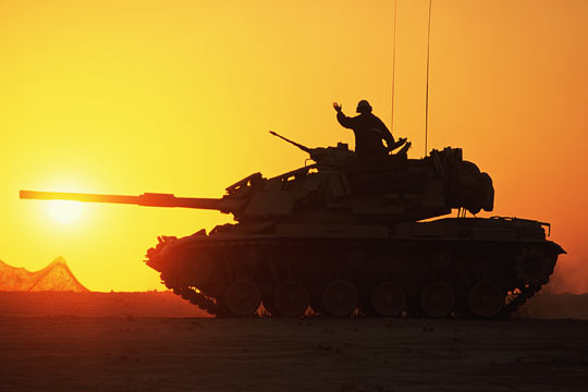 An American M60 main battle tank rolls through the Saudi Arabian desert during the Gulf War.