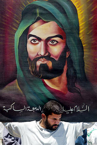 A Shiite Muslim holds a picture of historic Shiite leader Imam Hussein.