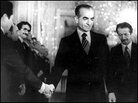 The shah shakes hands with a minister of the new civilian government, days before leaving Iran. The shah shakes hands with a minister of the new civilian government, days before leaving Iran.