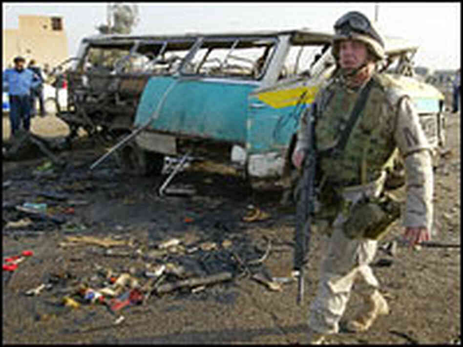 A U.S. soldier patrols the site of an explosion in Baghdad.