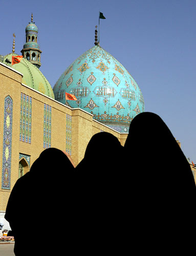 Women walk in the courtyard of the Jamkaran mosque outside the holy city of Qom, Iran. Women walk in the courtyard of the Jamkaran mosque outside the holy city of Qom, Iran.