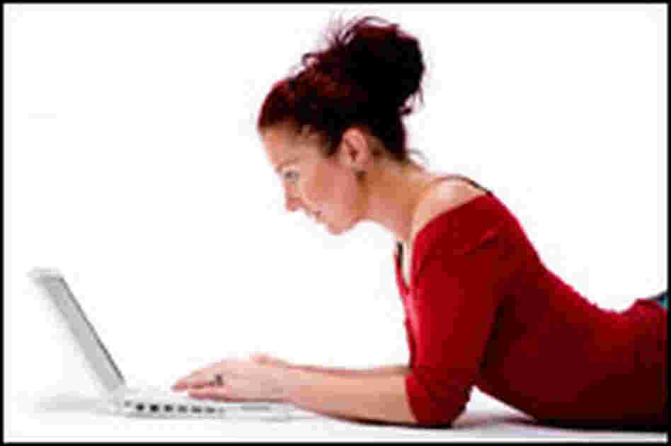 Girl listening to music on a computer Girl listening to music on a computer