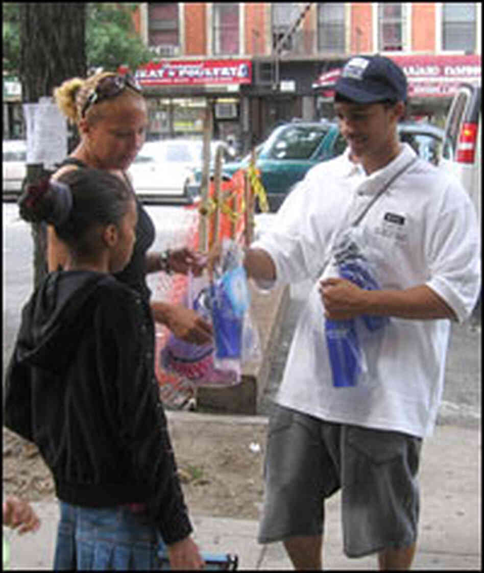 David Vasquez hands out empty city water bottles in Harlem.