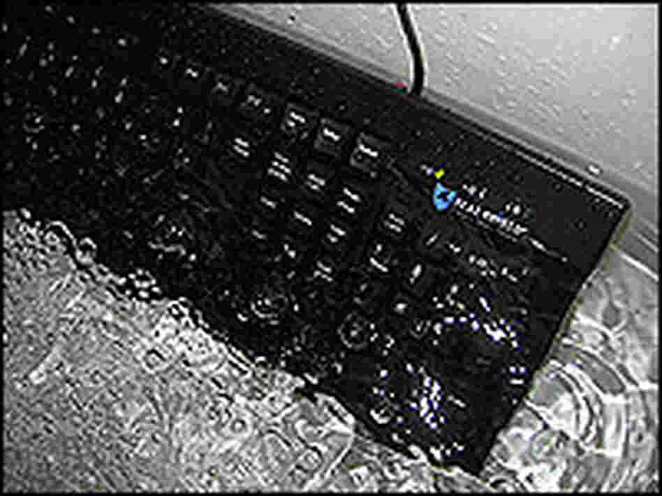 A Seal Shield computer keyboard is submerged in water in a bathtub. A Seal Shield computer keyboard is submerged in water in a bathtub.